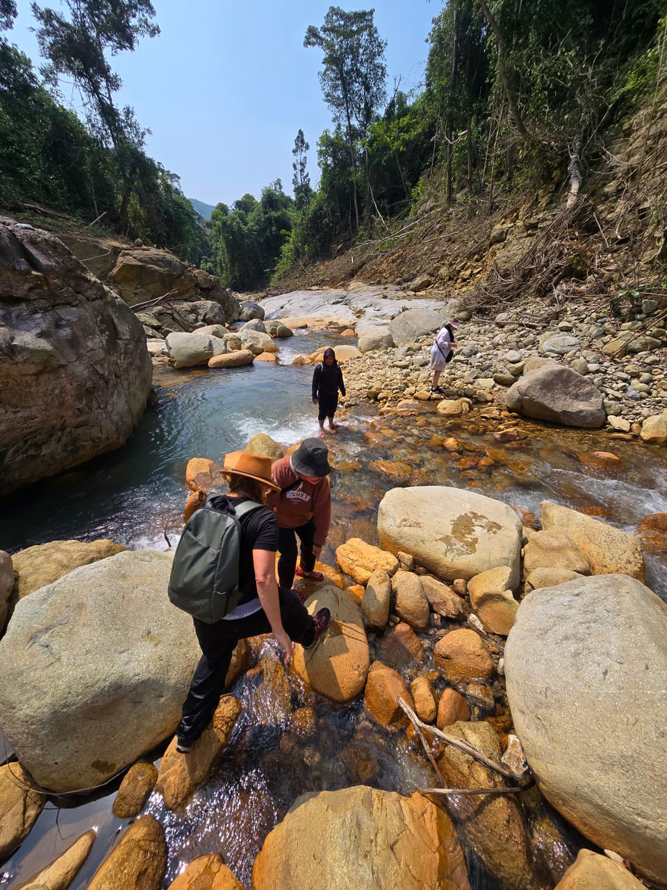 Trekking over the rocks to a jungle waterfall