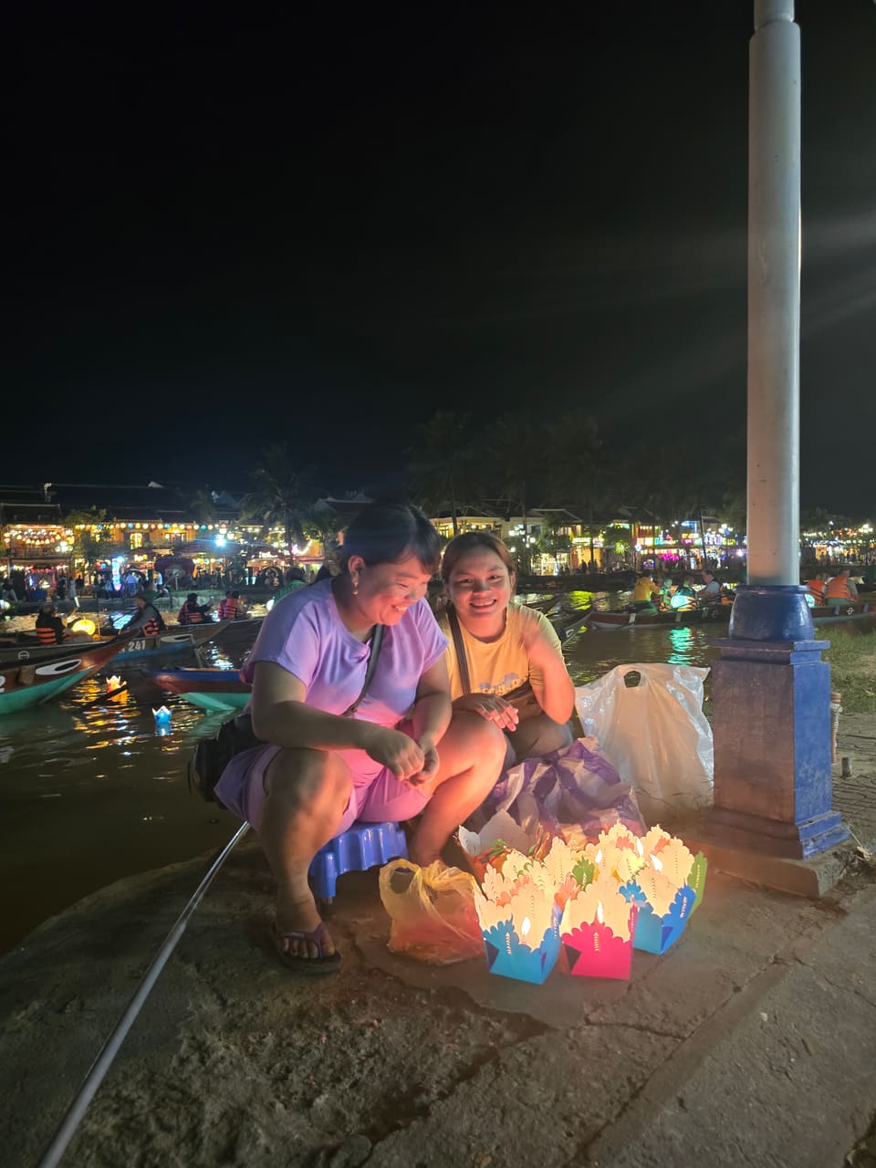 Lantern boats glowing on the Thu Bồn river after dark