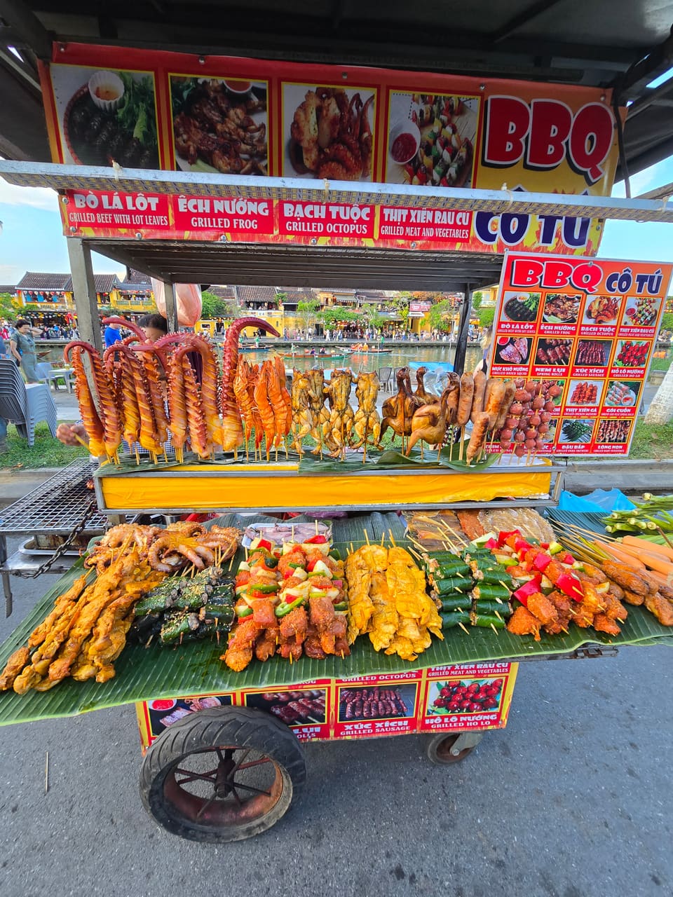 A street cart stacked with fresh bánh mì baguettes