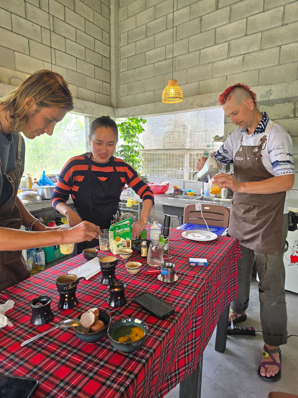 Guests chopping fresh herbs in a hands-on Vietnamese cooking class